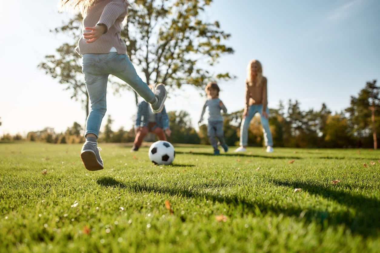 family playing soccer