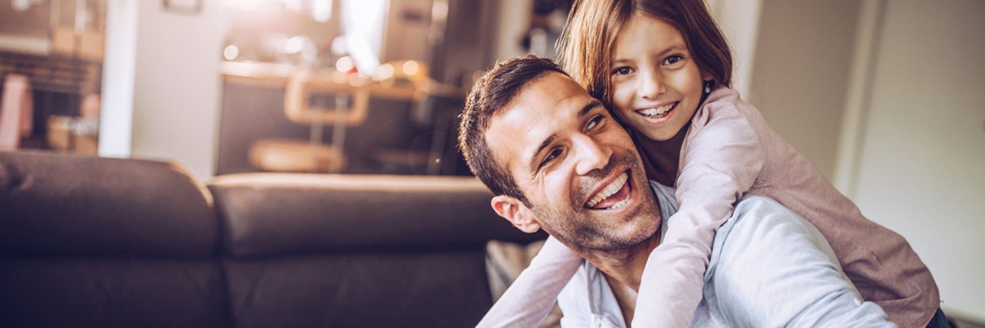 daughter hugging father from behind