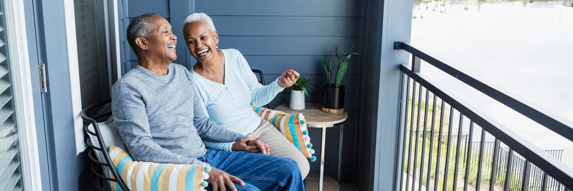 couple smiling and sitting on porch