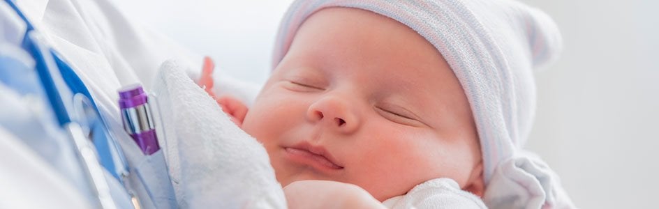 newborn baby in doctors arms