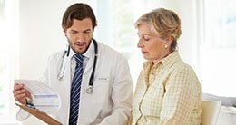 doctor talking to patient with paperwork