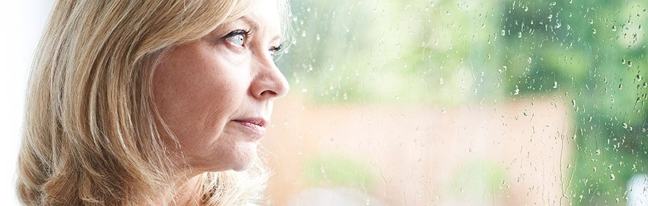 woman looking out window