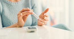 Woman testing blood sugar levels