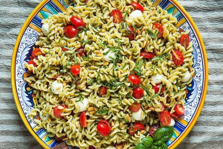 Pasta with pesto, mozzarella, and tomato