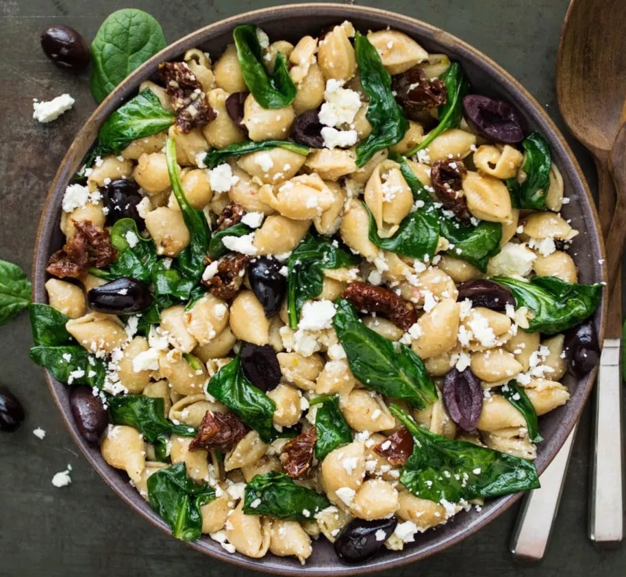 Bowl of pasta with olives and spinach