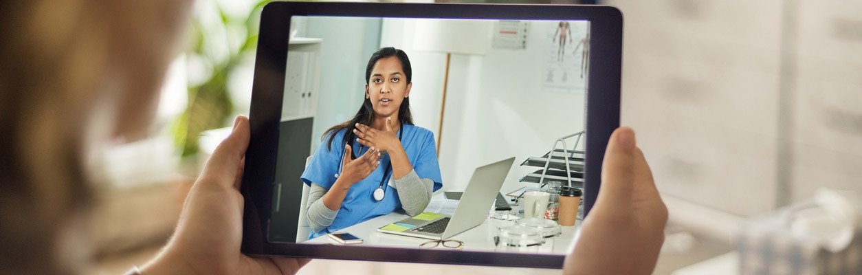 person speaking with physician through video visit