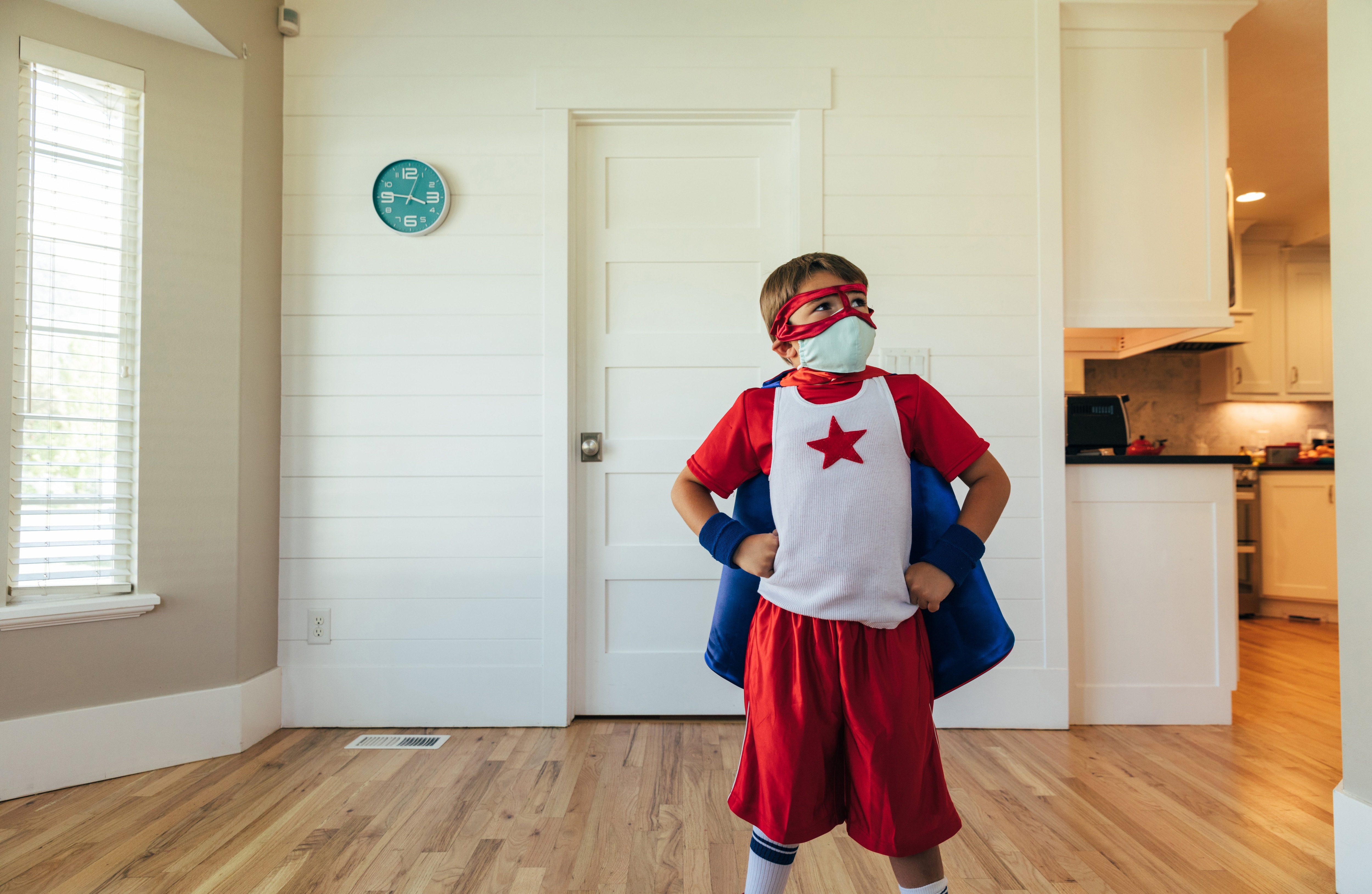 Little boy wearing mask and superhero costume