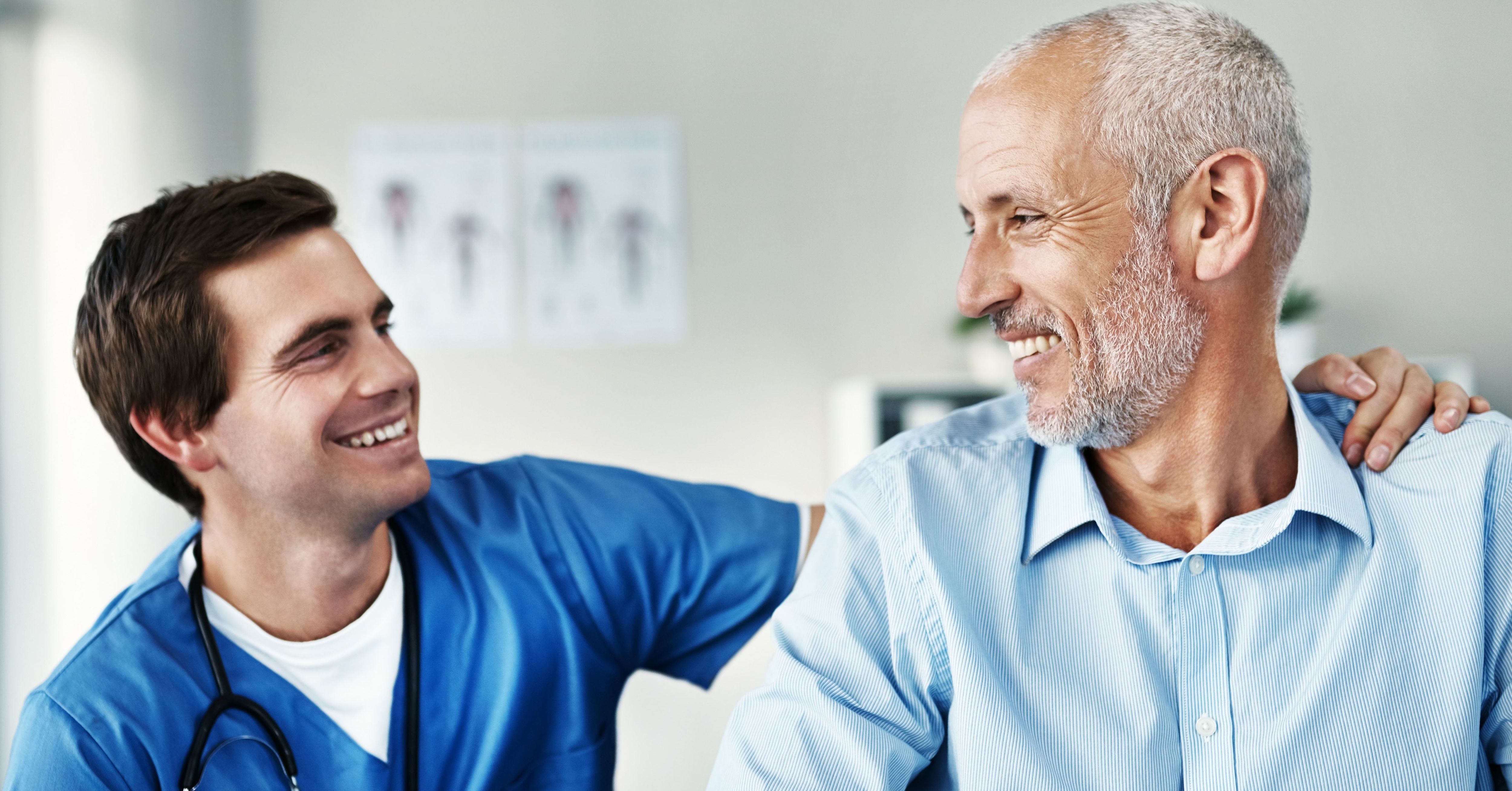 older man and medical provider smiling