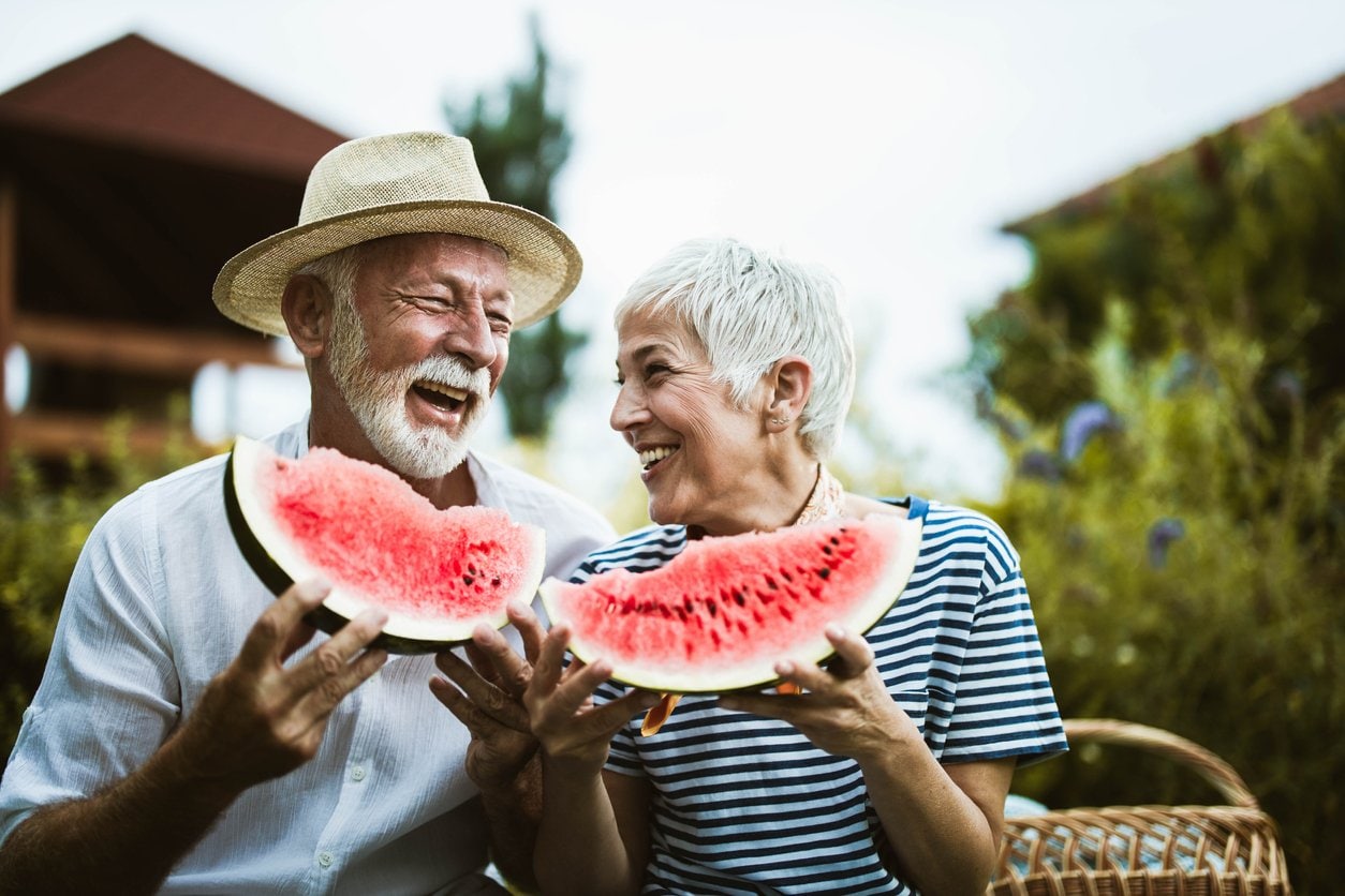 older couple enjoying watermelon