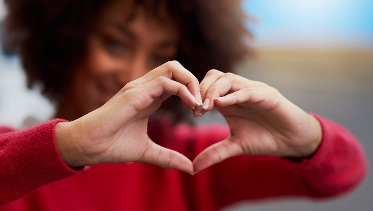 woman making a heart sign with her hands